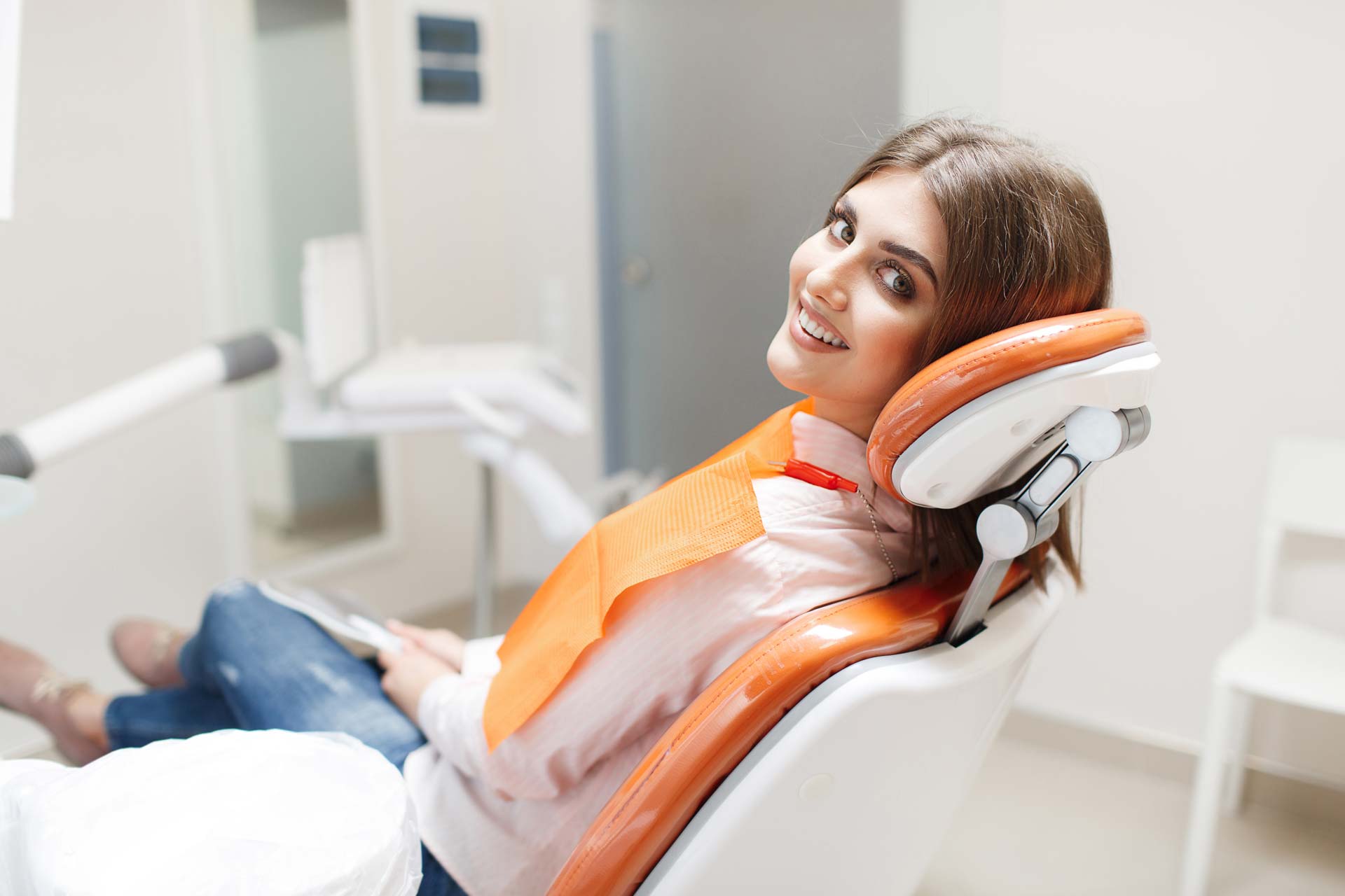 a patient smiling in a dentist chair