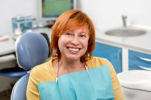 a smiling woman after a teeth cleaning