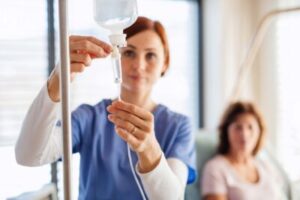 dental hygienist adjusting iv for sedation dentistry