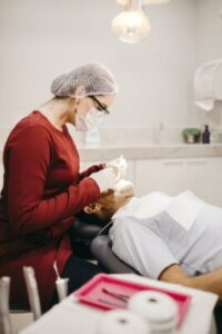 dentist performs exam on patient
