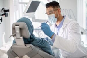 dentist examines patient