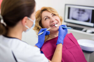 a happy patient being examined by a dentist