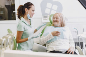 a happy patient being treated by a dental hygienist