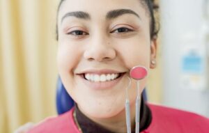 a smiling woman after a teeth cleaning