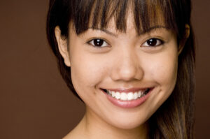 Asian dental patient with straight white teeth big smile