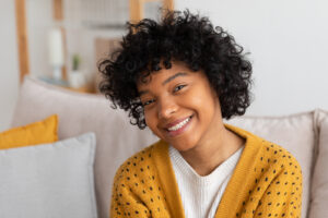 Young African American woman smiling after root canal therapy