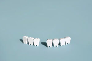 Picture of seven tooth figures in a row with a space in between them.